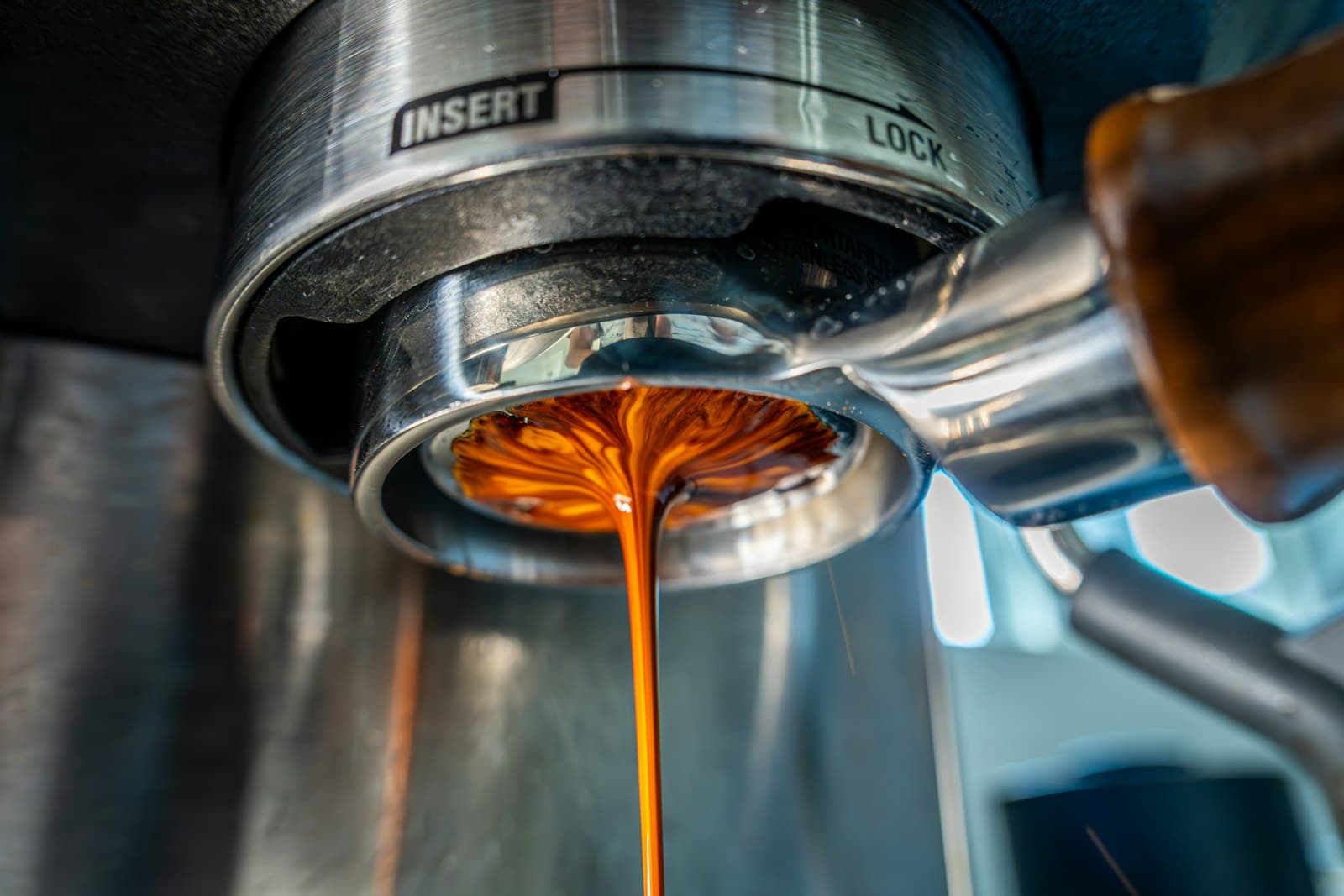 Fresh espresso pouring from a coffee machine portafilter