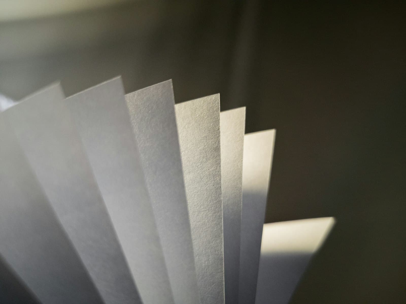 White paper coffee filters stacked on a gray surface