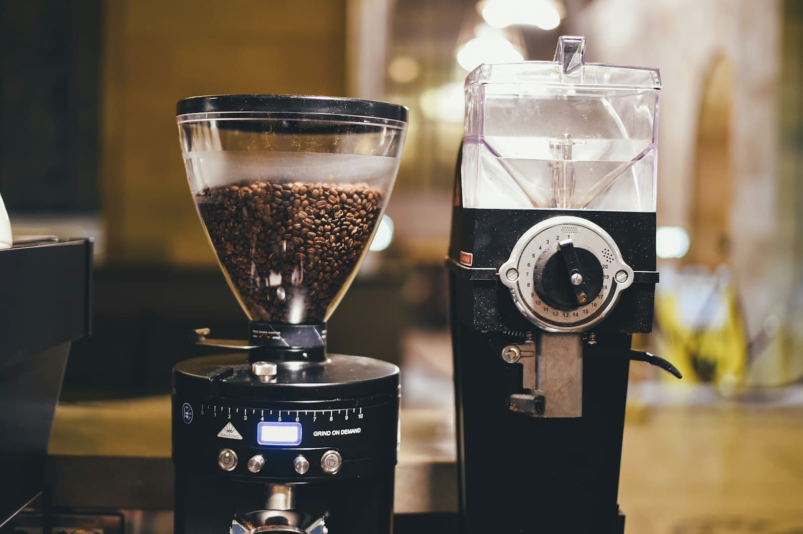 An upright electric burr coffee grinder on a counter