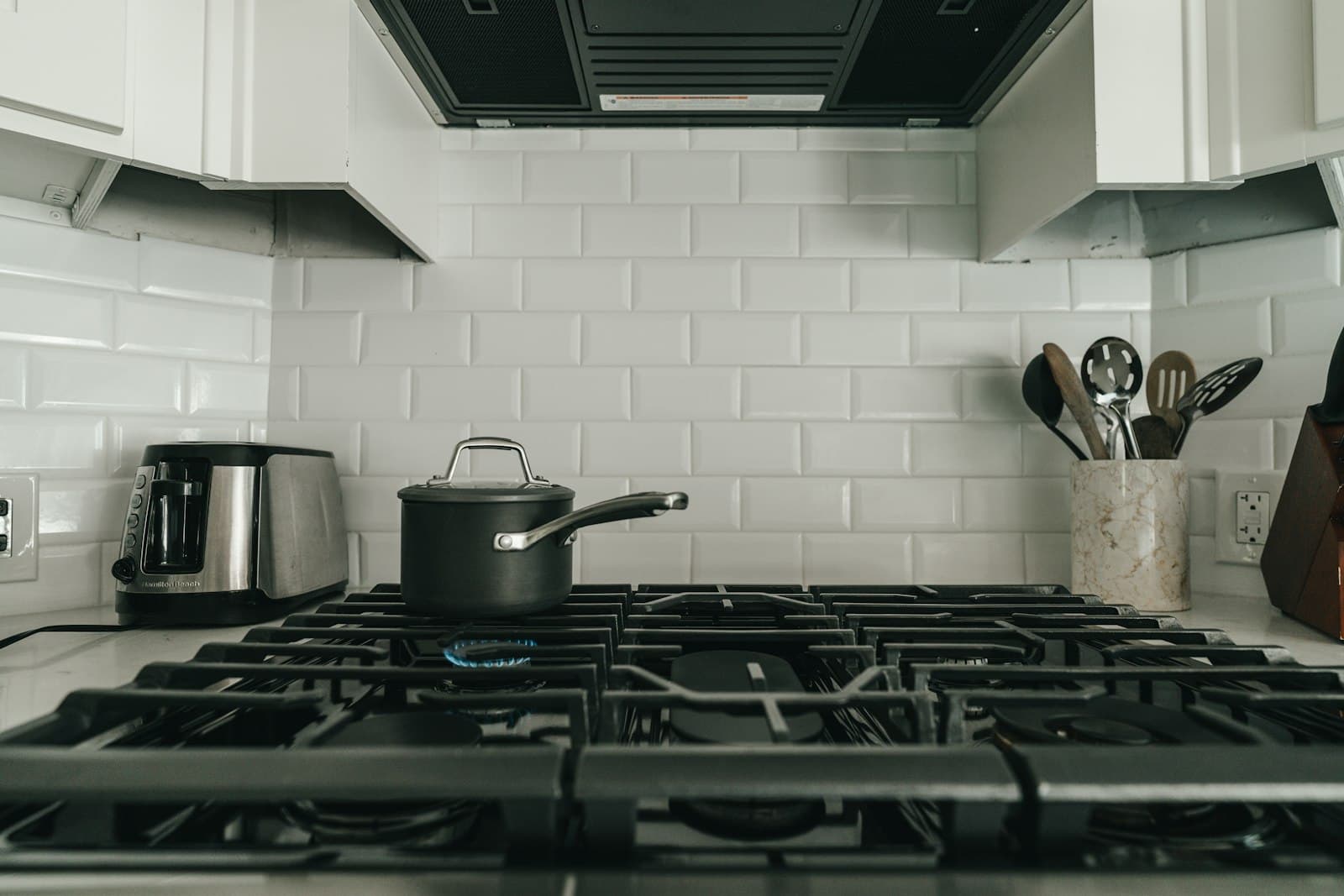 A moka pot brewing on a kitchen stovetop