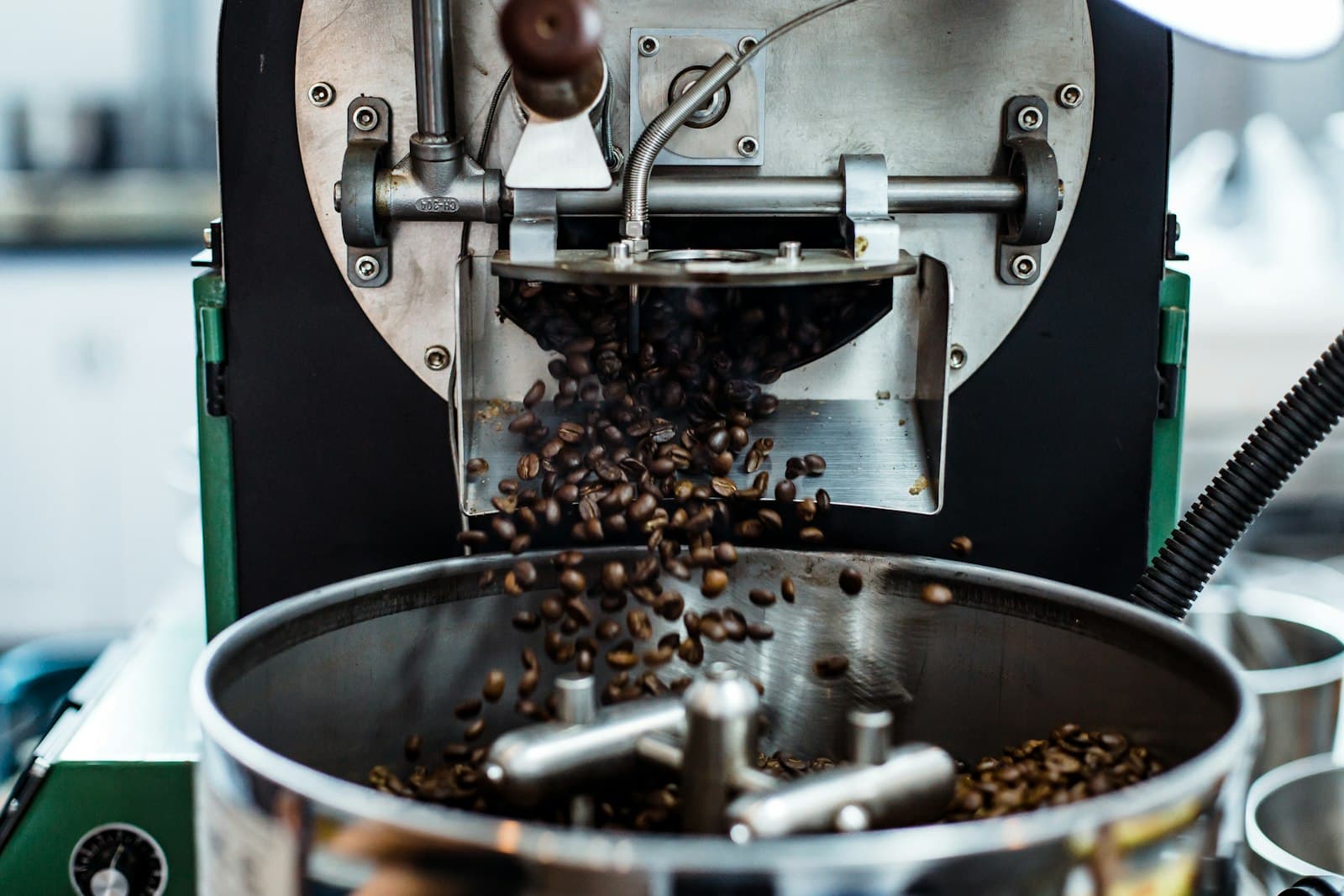 Coffee beans mid-grind scattering across a surface