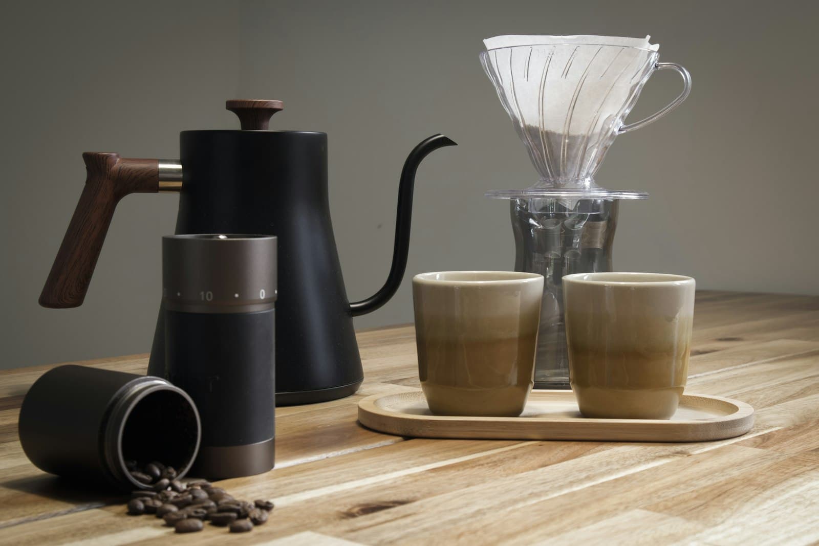 Several coffee brewing devices arranged on a wooden surface