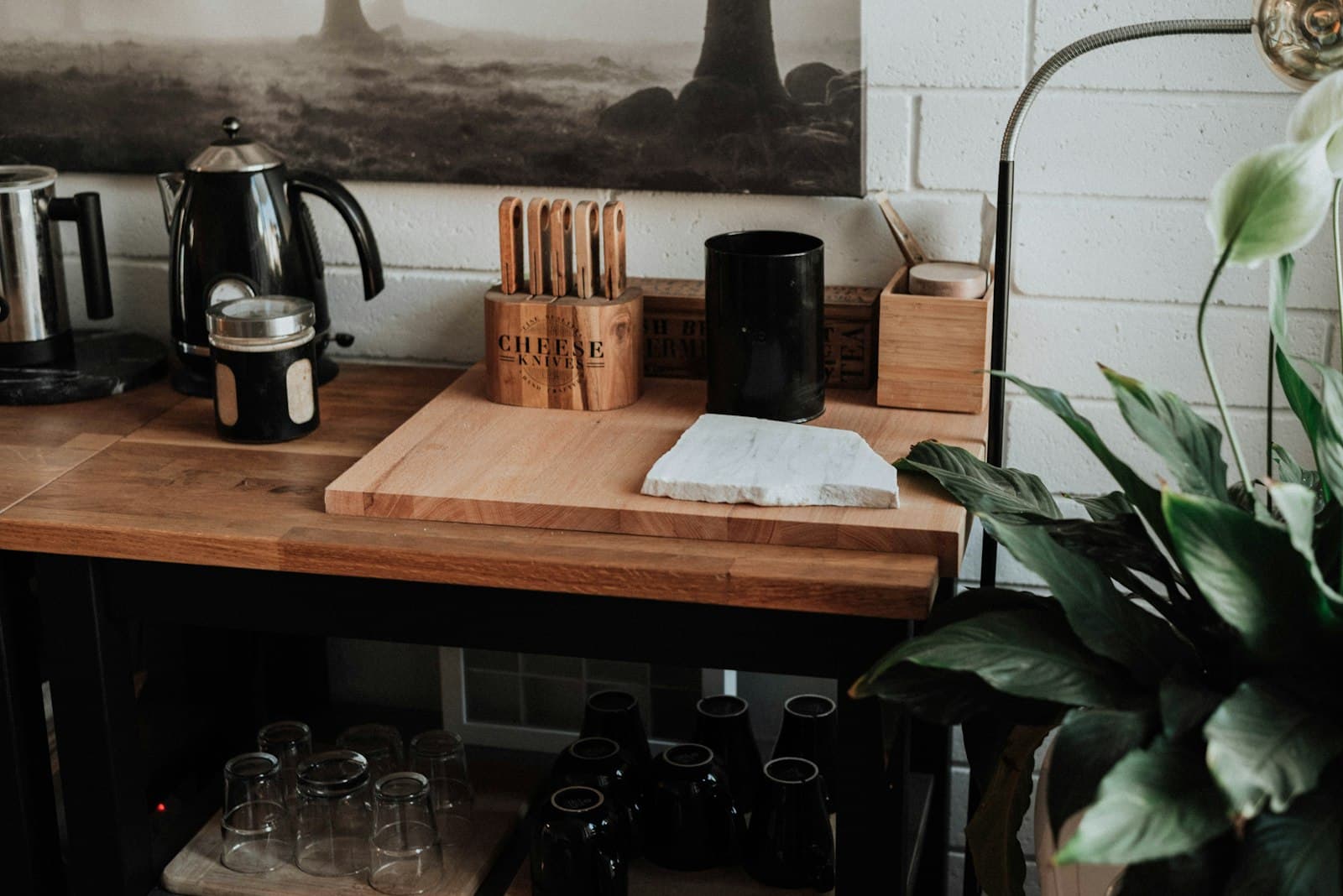 A compact wooden organizer holding a small coffee setup