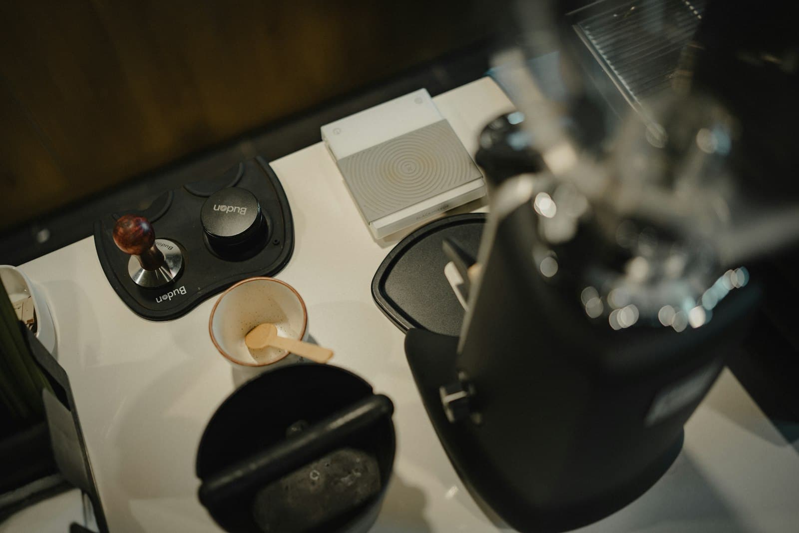 An espresso machine and coffee tools arranged on a counter