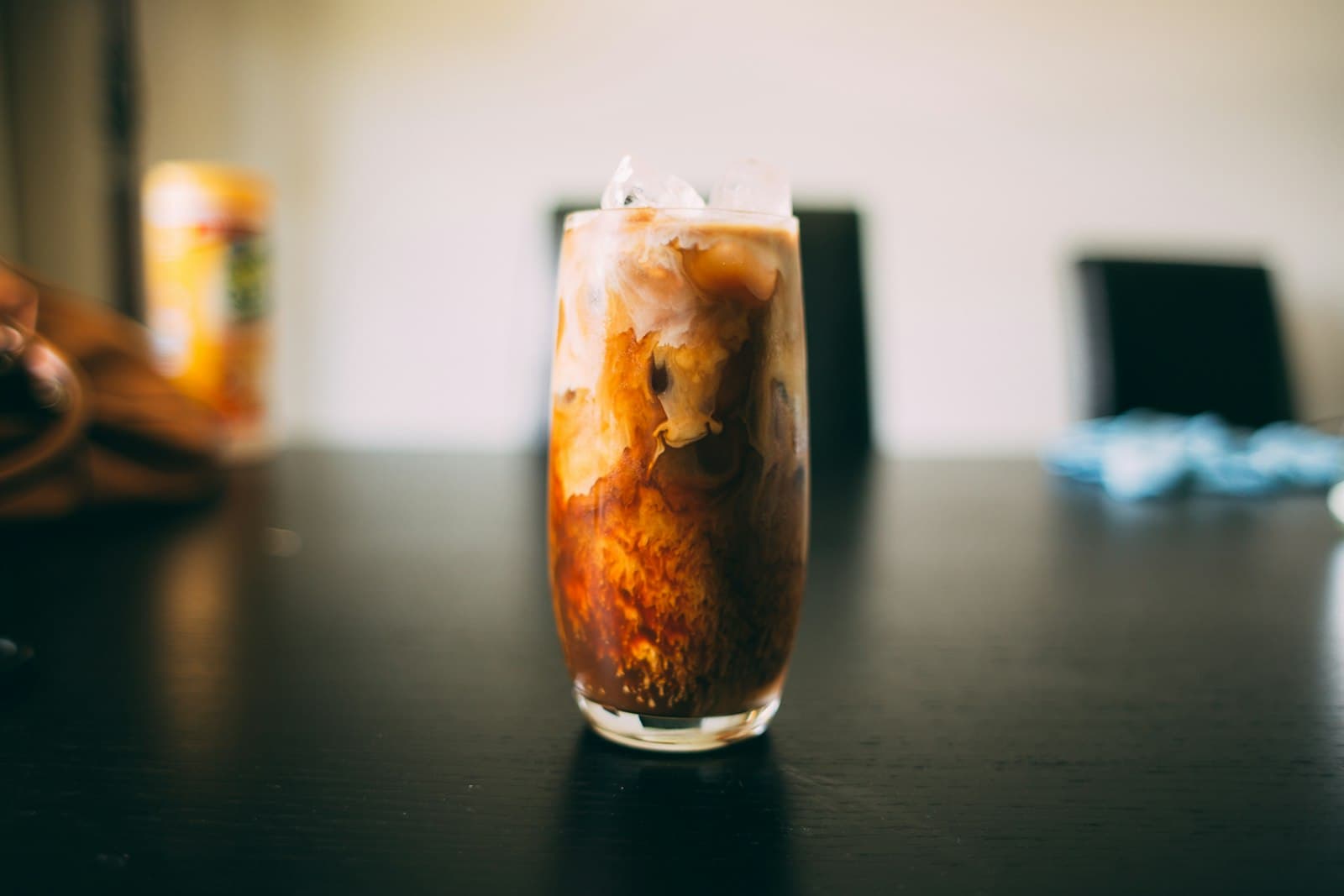 A glass of dark cold brew concentrate on a table