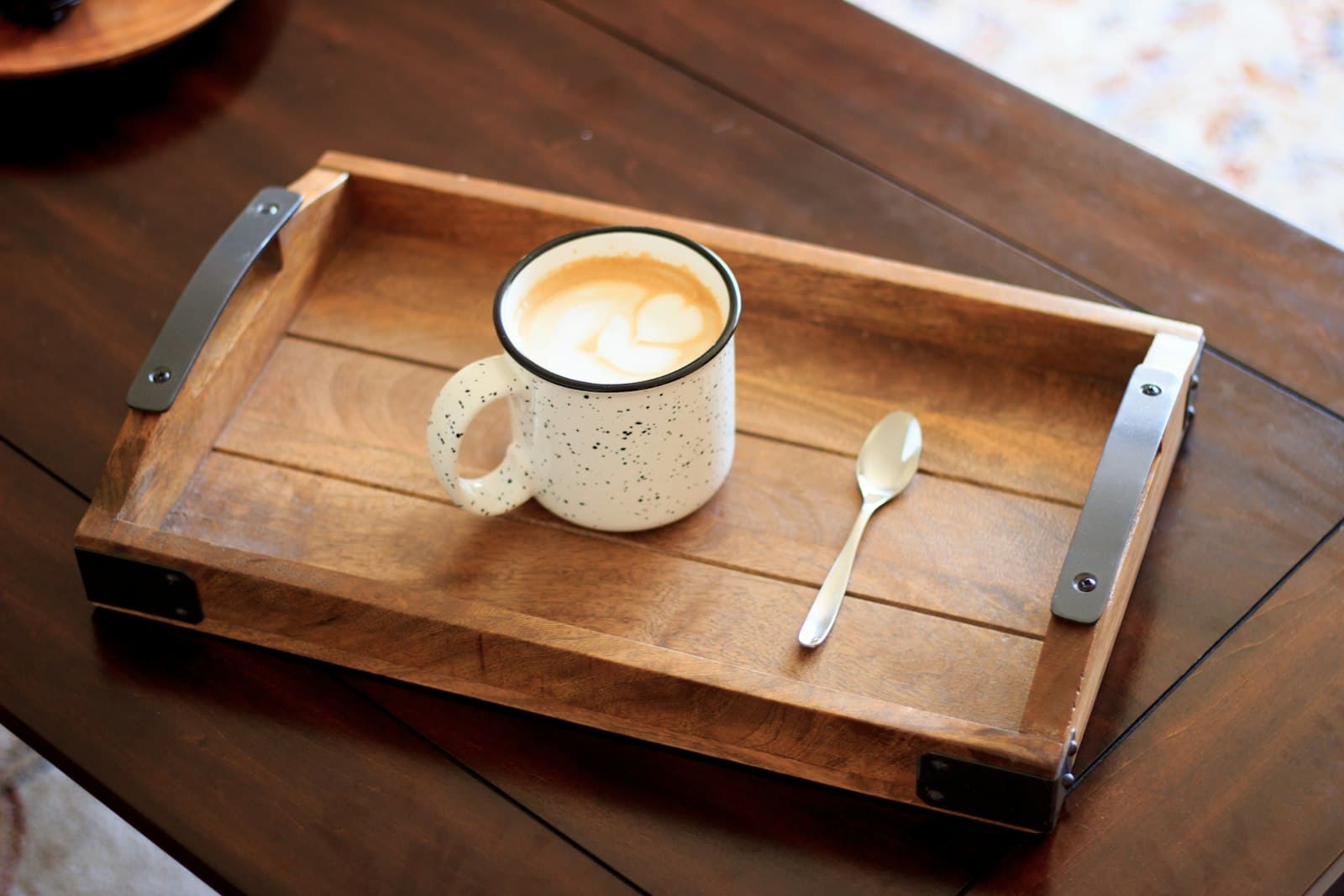 A white ceramic mug on a wooden serving tray